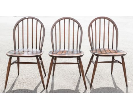 Three Ercol dark elm seated and beech framed Windsor stick back chairs, all bearing original labels (3) 