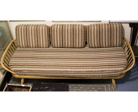 An Ercol Windsor light beech three seater sofa or day bed, spindle sides, on tapered legs