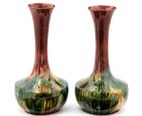 Christopher Dresser for Linthorpe (attributed), a pair of Art Pottery vases, squat shouldered form with elongated necks, red 