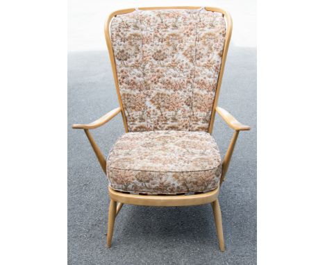 An Ercol Windsor light beech wing back armchair, spindle back, on tapered legs
