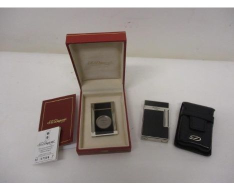 A DuPont white metal and lacquered cigar cutter no 87994 with certificate and booklet in a hardcase and a matching cigarette 