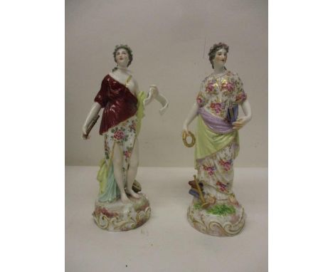 A pair of late 19th century German classical figures, each of a woman, one holding a wreath and a book with a horn and books 