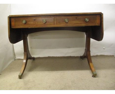 An early 19th century boxwood and ebony, string inlaid mahogany sofa table with a crossbanded top, over two inline drawers, t