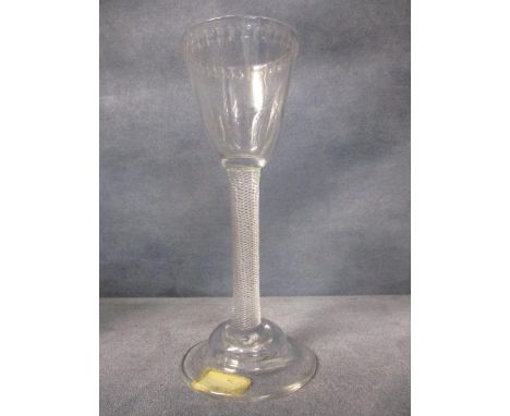 A George III wine glass, with a round funnel bowl, a band of engraved lines between polished circles to the rim on a plain, m