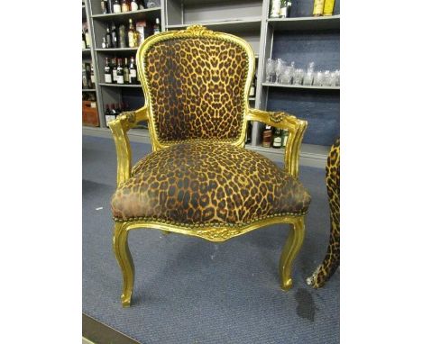 A French gilt wood open armchair with leopard print upholstered back and overstuffed seat 