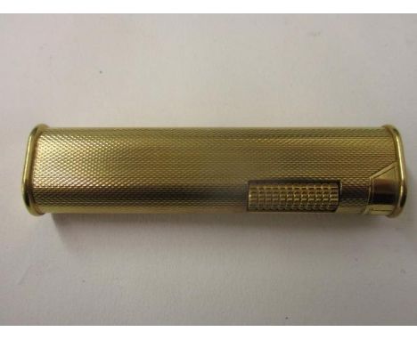 A Dunhill gold plated Butain dress lighter with rounded sides and engine turned body 