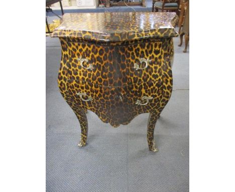 A contemporary leopard print French style bedside chest of two short drawers on cabriole legs, reputedly from Knights of Beac