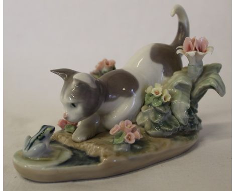 Lladro cat staring at a frog