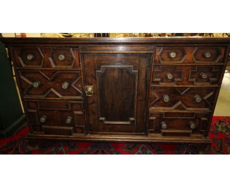 Old oak sideboard with moulded drawers fronts and central cupboard door, on bracket feet, 144cm wide x 44cm deep x 86cm high