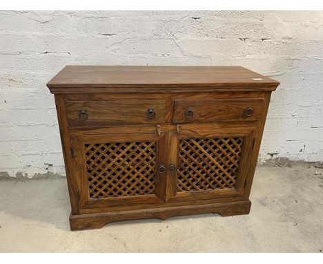 A South American hardwood side cabinet, the rectangular top above a moulded frieze and two short drawers and two trellis cupb