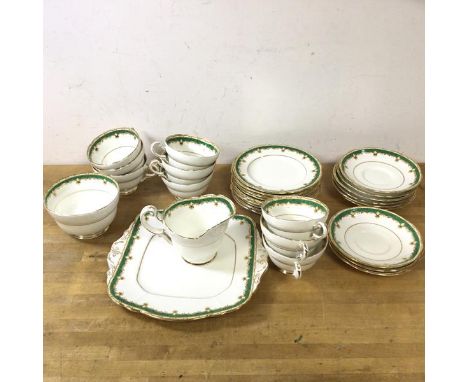 A Paragon tea set including nine teacups, each measuring 6cm high, with nine saucers, nine side plates, milk jug, sugar bowl 