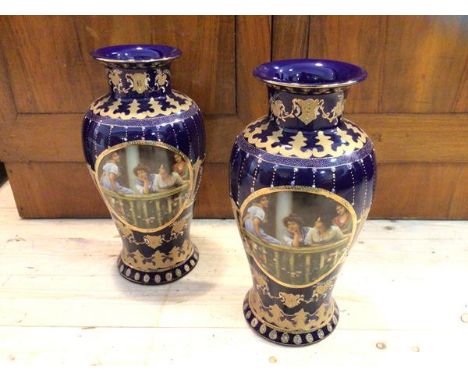 A pair of Royal Limoges baluster shaped vases with gilt and enamel decoration on blue ground, both with panel depicting women