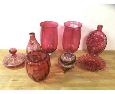 A collection of cranberry glass including two tulip shaped footed vases, measuring 21cm high,  a bottle shaped vase, ashtray,