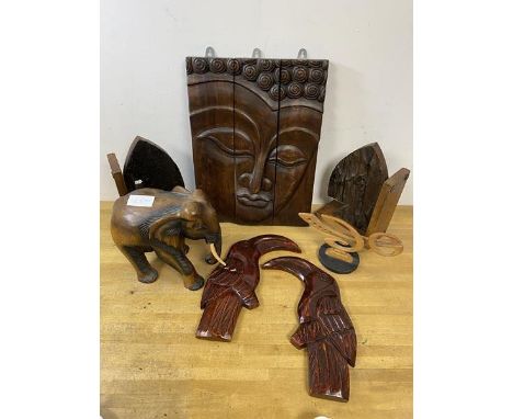 A quantity of carvings including south east Asian sectional wall panel depicting woman's face, measures 41cm x 30cm, elephant