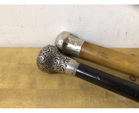 A late 19thc/20thc ebonised walking stick, with silver caps, measure 92cm long, and a Malacca style stick with silver knop to