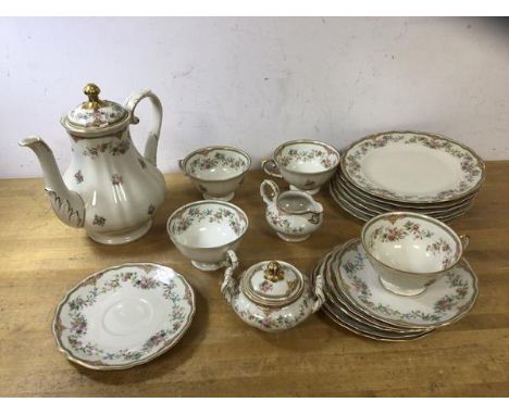 A part German teaset including teapot which measures 22cm high, four teacups, six saucers, six side plates, milk jug and suga