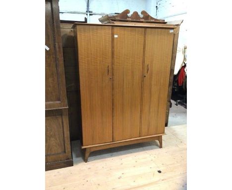 A mid century teak AC Handcraft triple door wardrobe with two doors in front of hanging space, single door in front of hangin