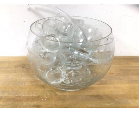 An etched glass punch bowl with leaf and fruit vine decoration, measures 20cm high x 28cm, chip to inner rim, along with ladl