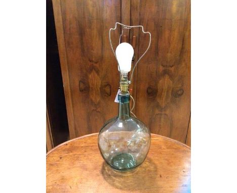 A glass bottle table lamp base of bulbous form, a/f,  measures 40cm to top of lampholder