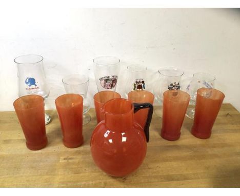 A set of six red grapefruit coloured tall glasses, each measures 14cm high, with matching pitcher, along with a collection of