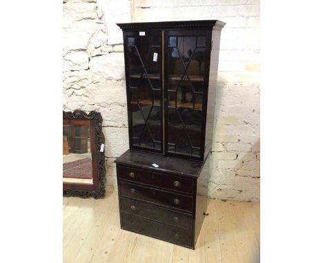 An Edwardian mahogany two-part bookcase, the dentil cornice above a pair of glazed astragal panel doors with brass rule edge 