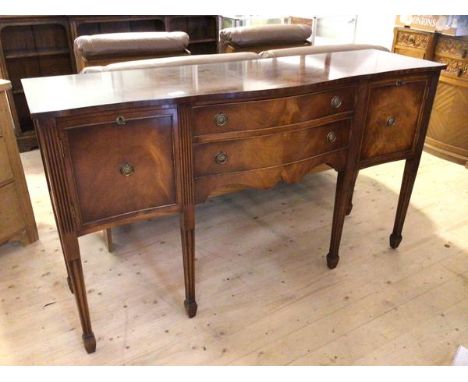 A Bevan Funnel Reprodux reproduction Georgian style serpentine sideboard, label to interior, with two drawers flanked by two 