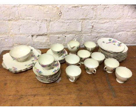 A 1930's Foley teaset including ten teacups, each measuring 7cm high, twelve saucers, twelve side plates, two cake plates, mi