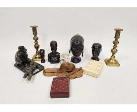 Group of carved ebony African heads, a carved Inuit art sculpture, a pair of brass baluster candlesticks, a cedar wood carvin