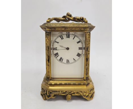 French late 19th century gilt-brass mounted carriage clock, with figural swing handle above bevelled glass panels, the white 