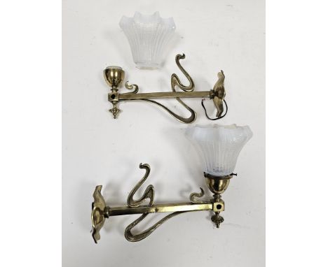 Pair of Art Nouveau brass wall lights with whiplash design decoration, the sconces inscribed 'Hubbell', with two fluted vasel
