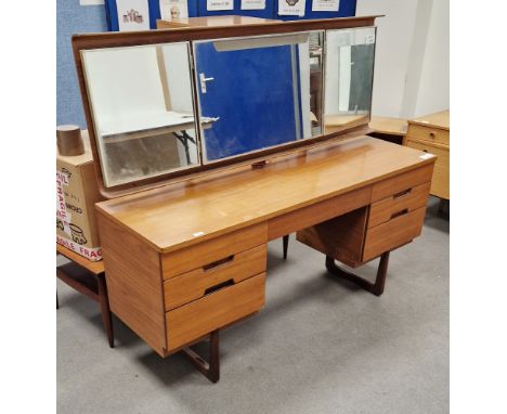 Mid-century teak Uniflex dressing table&nbsp;with folding three-section mirror raised over a single long drawer and six short