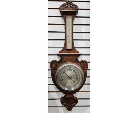 Early 20th century banjo barometer&nbsp;in ornately carved and decorated oak case, mercury thermometer, 19cm silvered dial wi