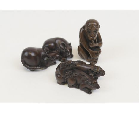 Carved rosewood netsuke formed as rats, 5cm; also another formed as a pair of rats, 6cm; and another of a seated monkey, 5cm 