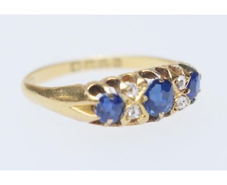 Sapphire and diamond cluster ring, hallmarked Chester 1896, the central oval cut sapphire of approx. 0.25ct, flanked by four 