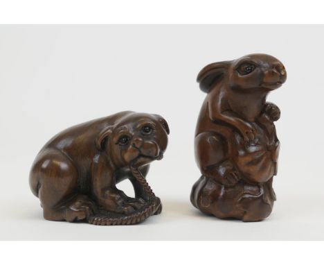 Carved rosewood netsuke of a dog playing with a slipper, 4cm; also another of a rabbit and a squash, 5cm (2) (Please note con
