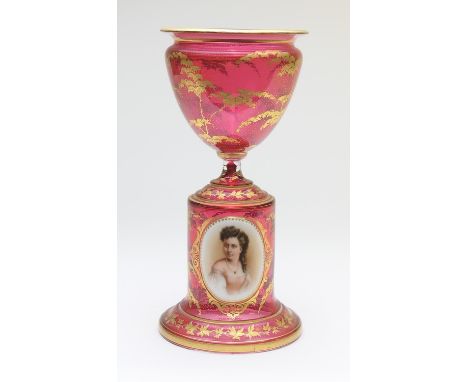 Bohemian ruby glass pedestal bowl, decorated with foliage, the cylinder base with an applied hand painted cameo portrait of a