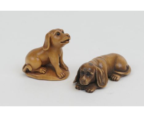 Carved wooden netsuke of a recumbent dog, 6.5cm; and another of a seated dog, 4.5cm (2) (Please note condition does not form 