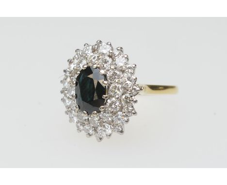 Sapphire and diamond cluster ring, the oval cut sapphire approx. 9mm x 7mm, bordered with 36 round cut diamonds totalling app