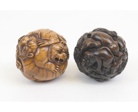 Carved wooden netsuke, spherical form carved with fighting tigers, 5cm; also a rosewood netsuke carved with a variety of figh