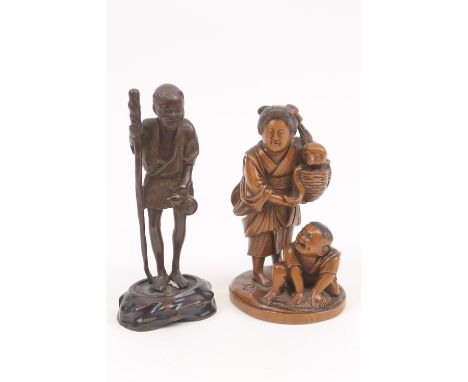 Japanese carved wooden okimono, Meiji (1868-1912), carved as a fisherwoman holding a basket with octopus, and her son at the 