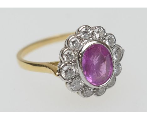 Diamond and pink sapphire (untested) cluster ring, the central untested stone of approx. 8mm x 6mm, in a millegrain collet mo
