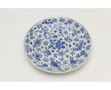 Chinese blue and white saucer dish, Kangxi (1662-1722), decorated with flowers and foliage, Jiajing six character mark, 16cm 