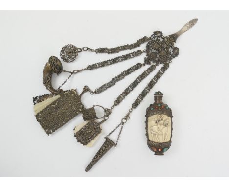 Continental pressed metal chatelaine, circa 1920, the clip supporting five elaborate chains with two note cases with celluloi