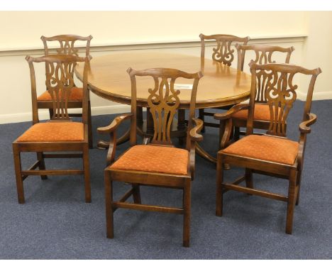 Quality oak extending dining table together with six (4+2) Chippendale style oak dining chairs, by Cumpers of Salisbury, the 
