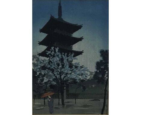 Japanese woodblock print in frame, depicting a female figure holding a parasol with a pagoda in the background, possibly afte