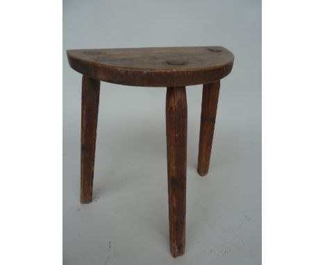 A tall pine stool on tripod legs with demi lune seat 61cm H