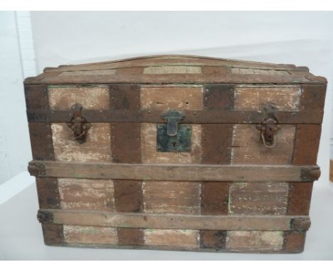 A wood and metal bound travel trunk 77 x 45 x 54cm