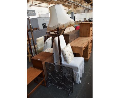 A black metal fire guard of scrolling design 66cmH together with a standing lamp with turned base and cream shade 