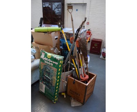 A selection of garden tools including various brushes and brooms, hoes, sheers, a Multigrow 200, a branch cutter and various 