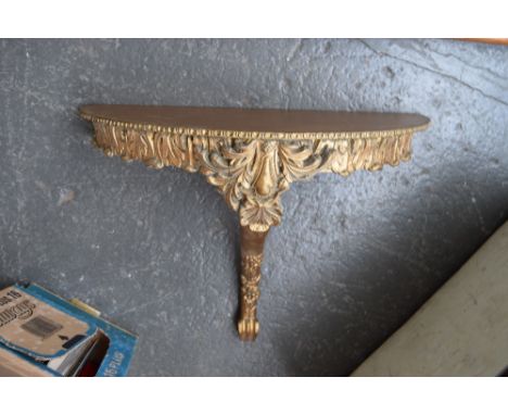 A gilt demi lune console table with foliate carved design on carved cabriole leg 60cmW